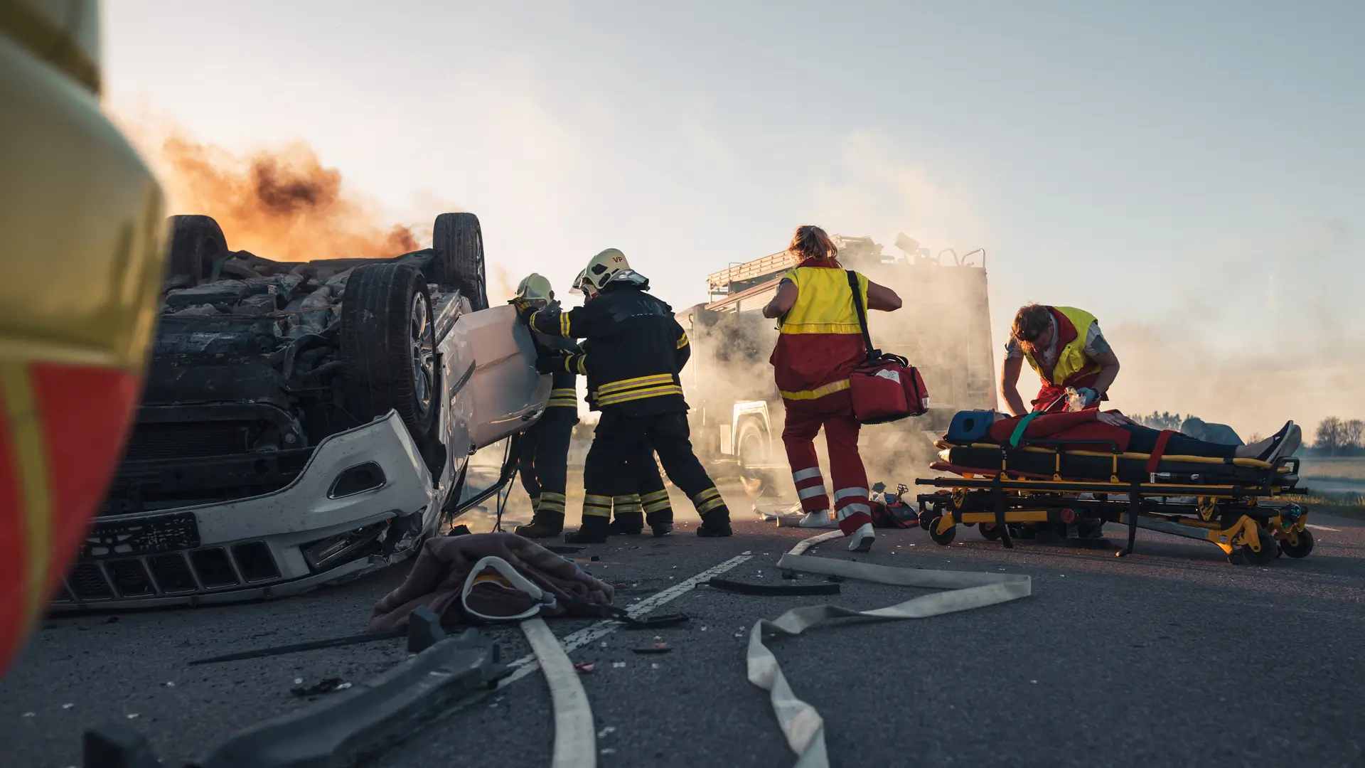 first responders approaching a flipped vehicle